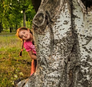 girl behind a tree